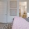a bedroom with a bed and a mirror