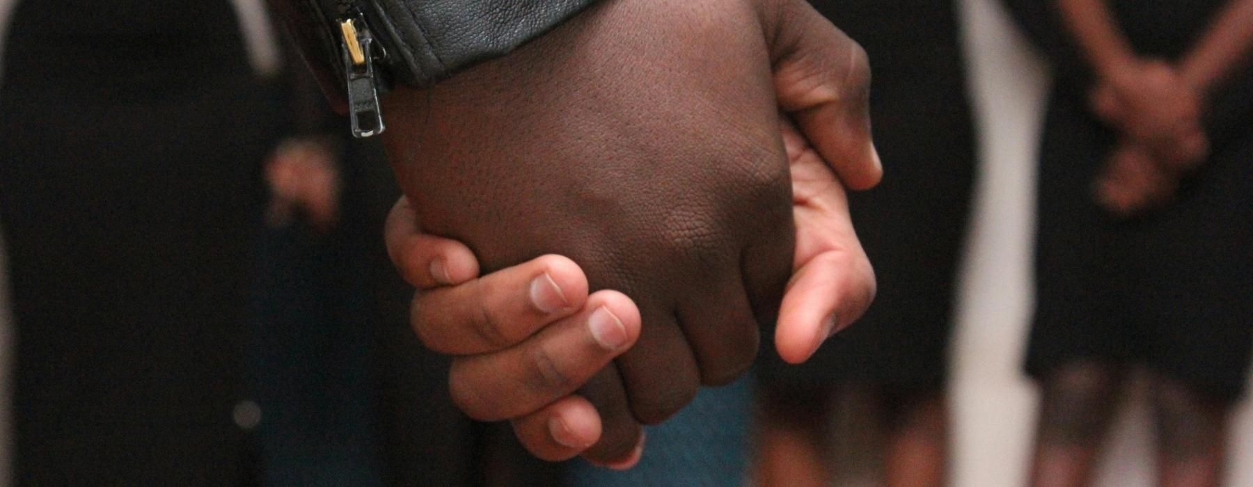 a close-up of a person holding the hands together