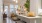 a kitchen with a sink and chairs