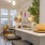 a kitchen with a sink and chairs
