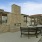 a patio with a table and chairs in front of a building