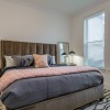 bedroom with nightstands and a large window
