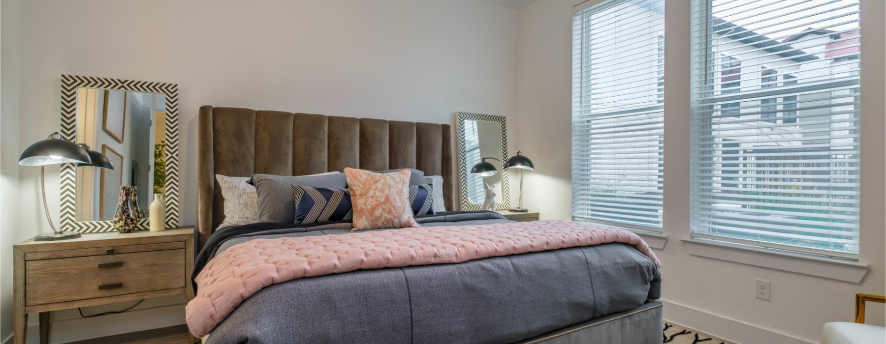 bedroom with nightstands and a large window