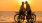 a man and woman on a bicycle