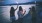 a group of girls holding sticks near the water