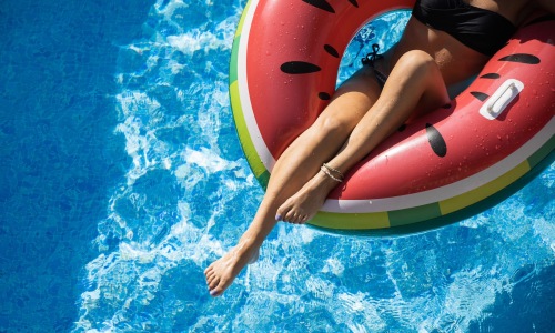a woman on a watermelon floaty