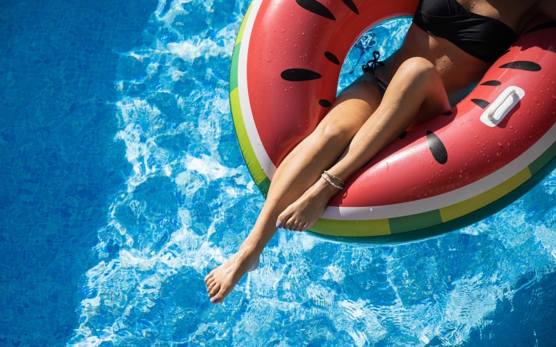 a woman on a watermelon floaty