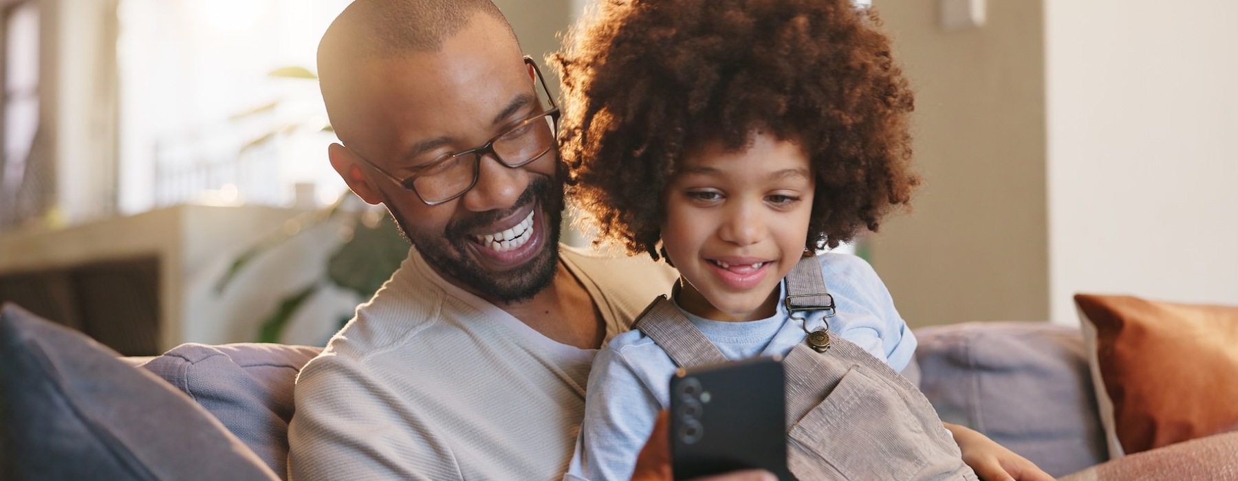 a man with a child looking at a phone