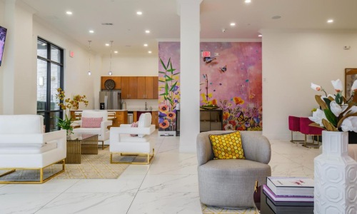 a room with a couch and chairs