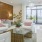 a living room with white couches and a glass table